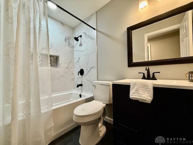 full bathroom featuring vanity, toilet, and shower / bath combo with shower curtain