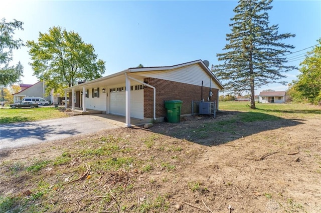 view of home's exterior featuring a garage and central air condition unit