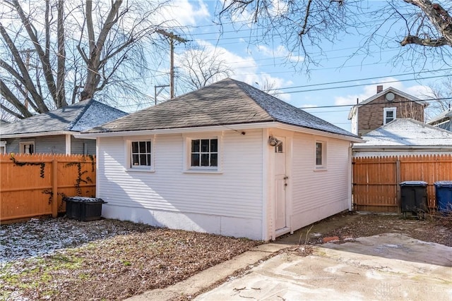 rear view of property with an outbuilding