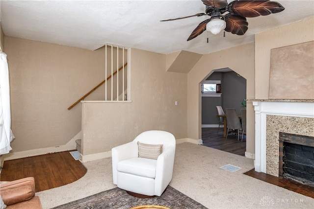 sitting room featuring ceiling fan and carpet