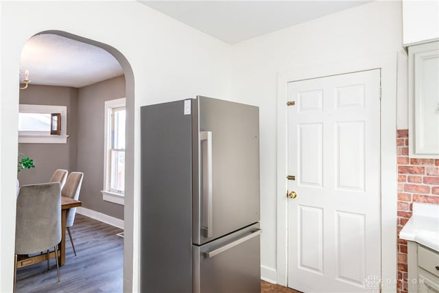 kitchen featuring hardwood / wood-style floors and stainless steel fridge