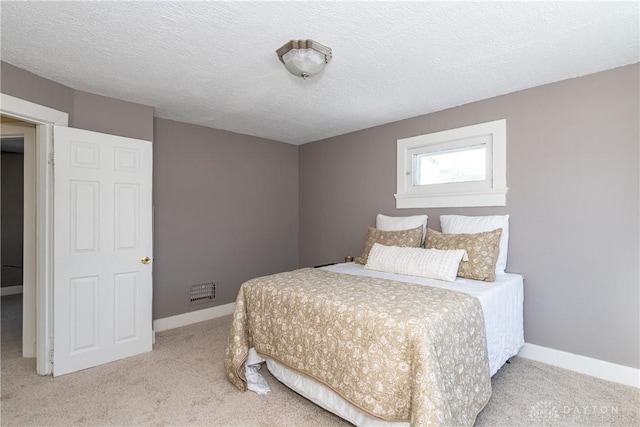 carpeted bedroom featuring a textured ceiling