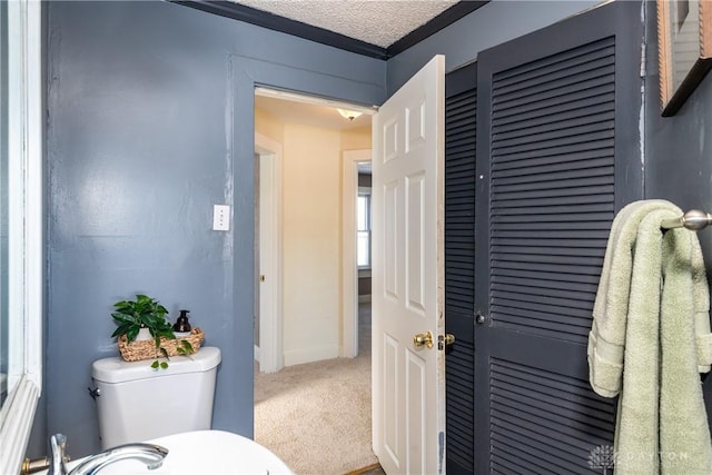 bathroom with a textured ceiling and toilet