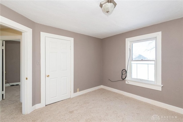 unfurnished bedroom featuring light colored carpet