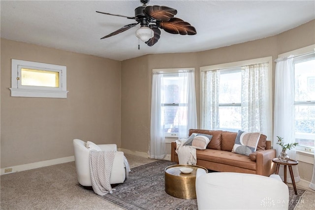 living room featuring ceiling fan, carpet, and plenty of natural light