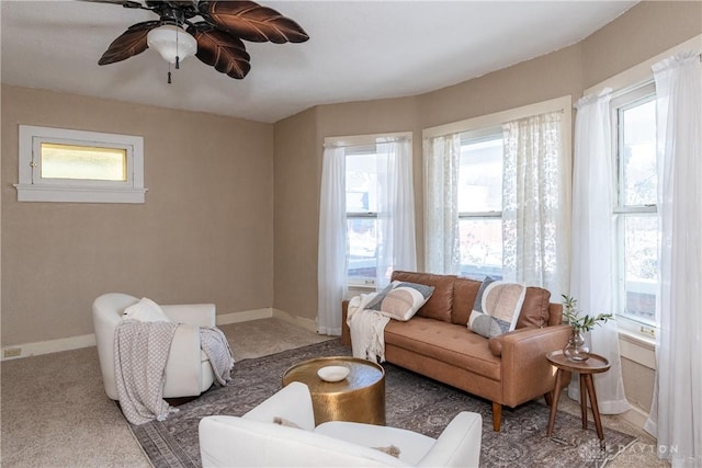 carpeted living room with ceiling fan