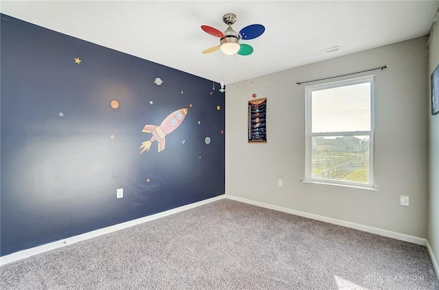 spare room with ceiling fan and carpet floors