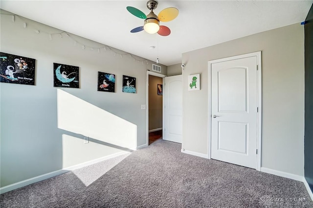 carpeted empty room with ceiling fan