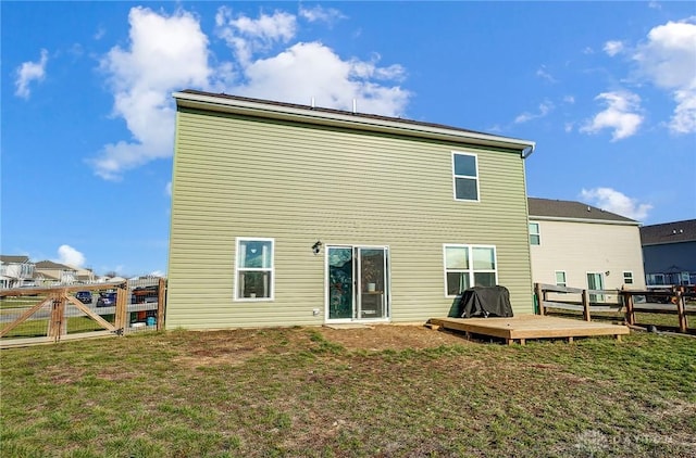 back of house featuring a yard and a wooden deck