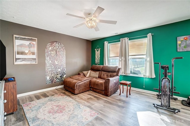 living room with hardwood / wood-style flooring and ceiling fan