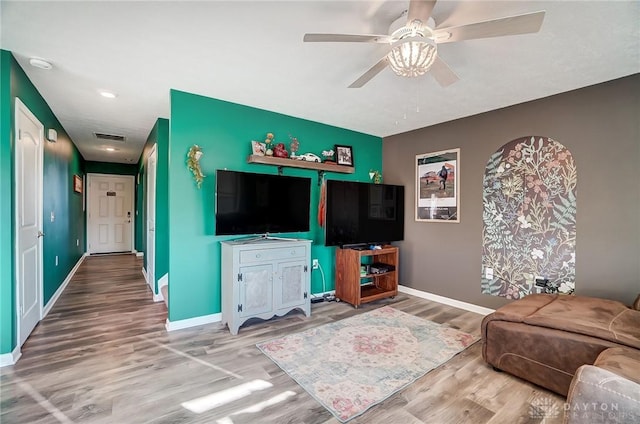 living room featuring hardwood / wood-style flooring and ceiling fan