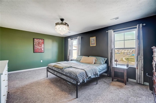 bedroom featuring carpet flooring, a chandelier, and a textured ceiling