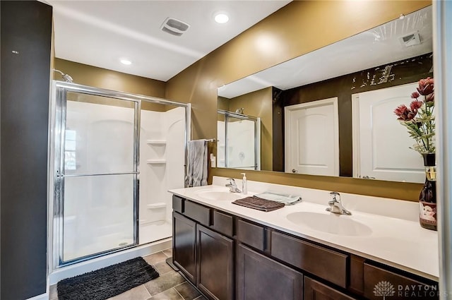 bathroom featuring tile patterned floors, vanity, and an enclosed shower