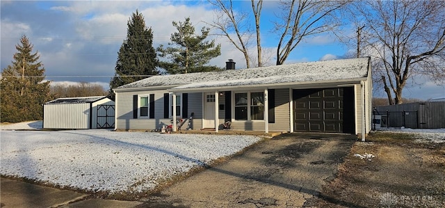 view of front of house featuring a garage and a shed