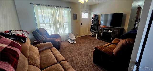 living room featuring ceiling fan and dark carpet