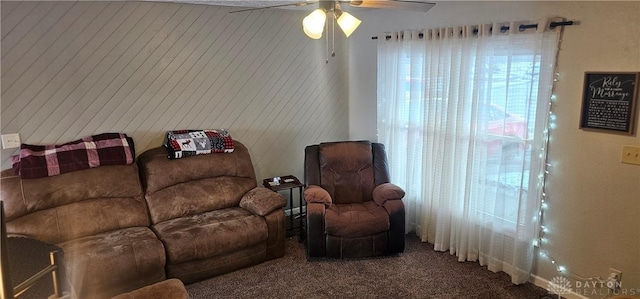 carpeted living room with ceiling fan