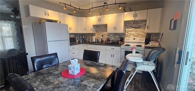 kitchen with tasteful backsplash, white cabinetry, ceiling fan, and white appliances