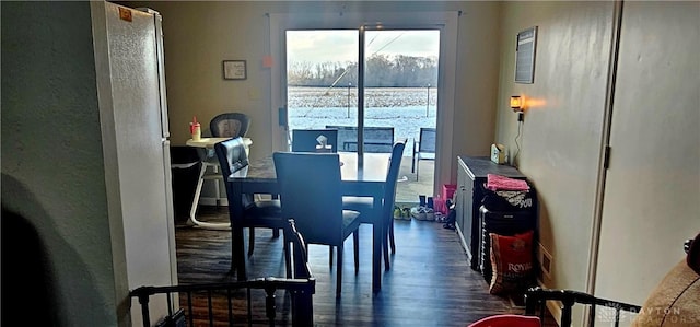 dining space with dark hardwood / wood-style flooring