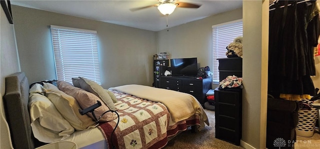 bedroom featuring ceiling fan and dark colored carpet