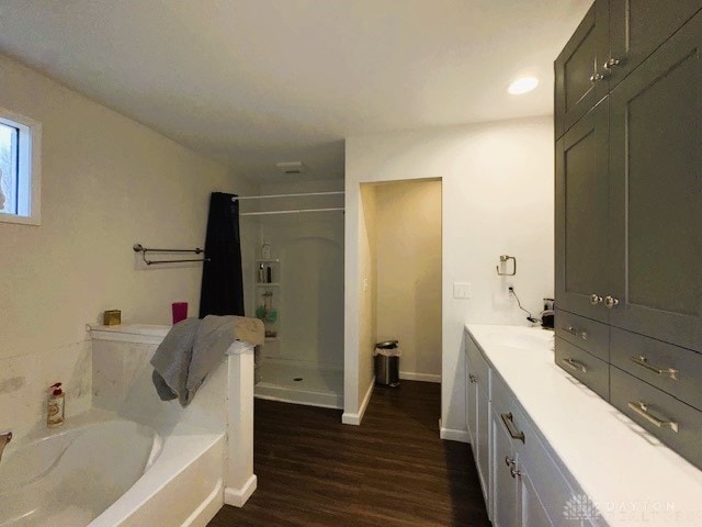 bathroom with vanity, hardwood / wood-style flooring, and independent shower and bath