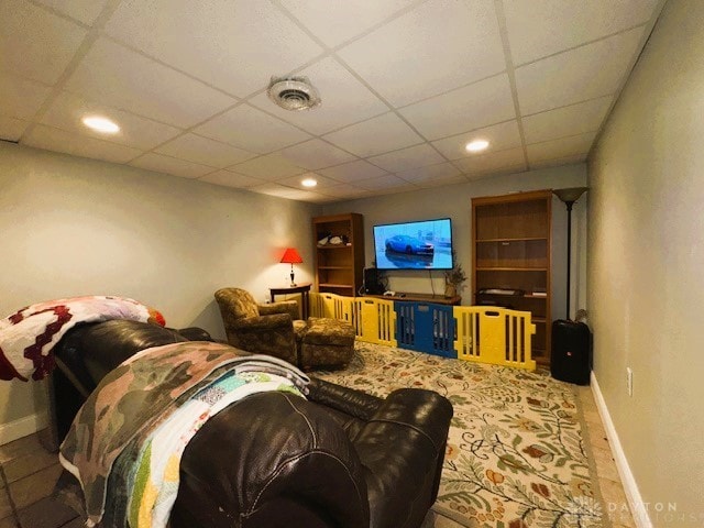 living room with a paneled ceiling