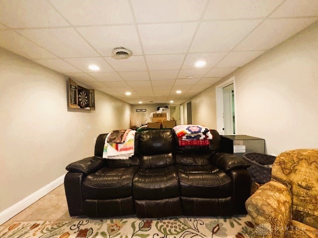 home theater with a paneled ceiling and light tile patterned flooring