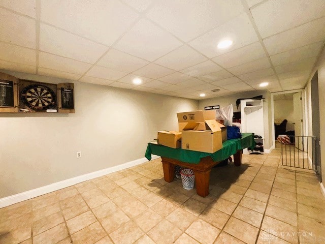 game room with a paneled ceiling