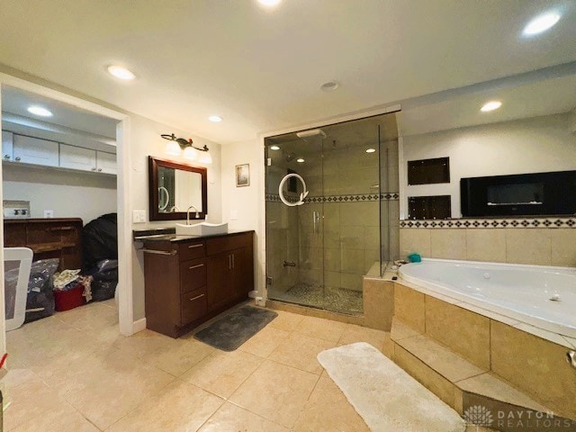 bathroom with plus walk in shower, vanity, and tile patterned floors