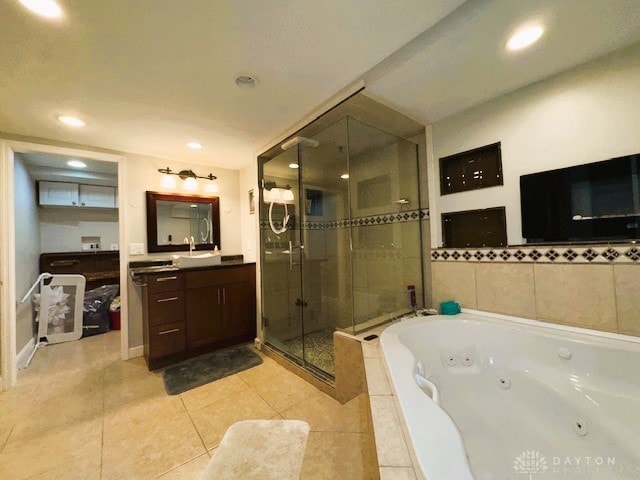 bathroom with tile patterned floors, vanity, and separate shower and tub