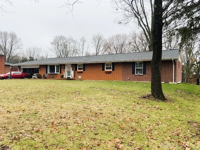 single story home with a front yard and a garage