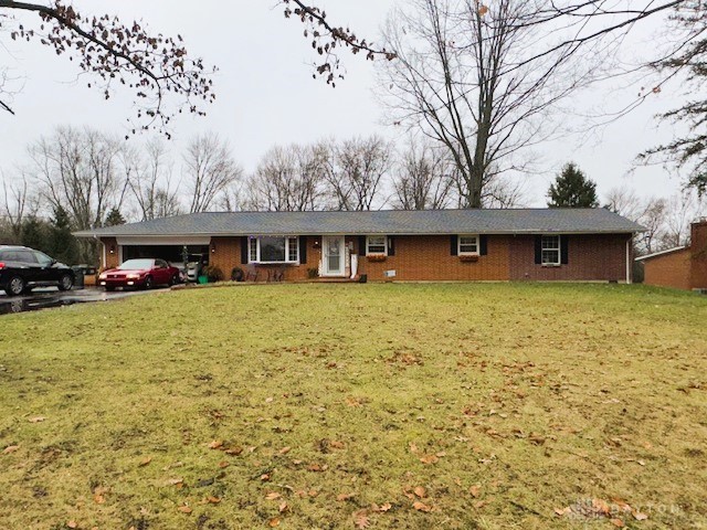 single story home with a garage and a front yard