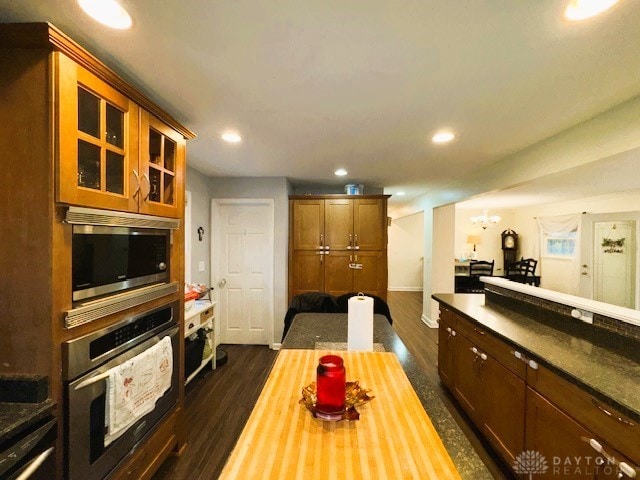 kitchen featuring butcher block counters, dark hardwood / wood-style flooring, and stainless steel appliances