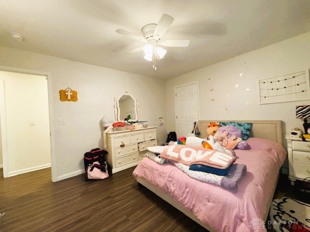 bedroom featuring ceiling fan and dark wood-type flooring