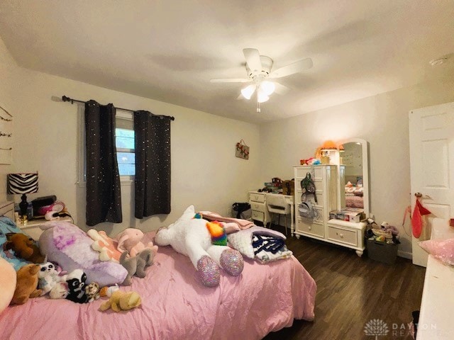 bedroom with ceiling fan and dark hardwood / wood-style floors