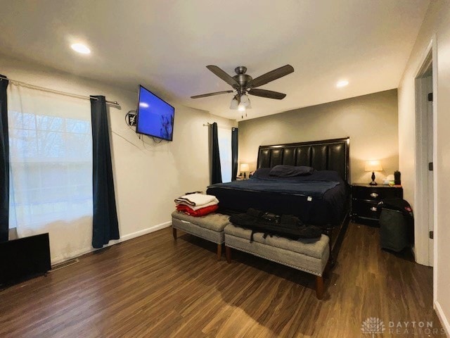 bedroom with dark hardwood / wood-style floors and ceiling fan