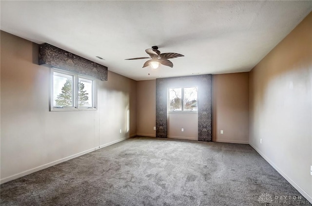 spare room with carpet, ceiling fan, and a healthy amount of sunlight