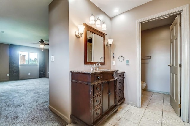 bathroom featuring ceiling fan, toilet, and vanity