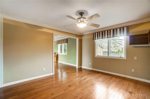 spare room featuring ceiling fan, light hardwood / wood-style flooring, and ornamental molding