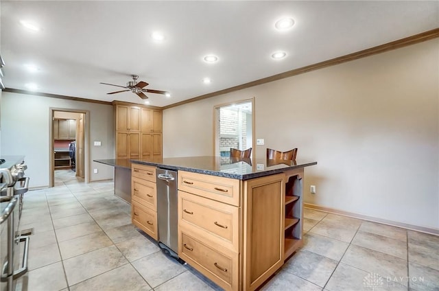 kitchen with ceiling fan, a center island, stainless steel range oven, and ornamental molding