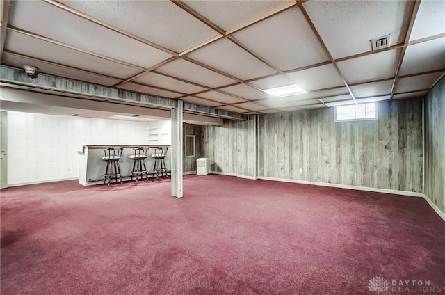 basement with carpet flooring and indoor bar