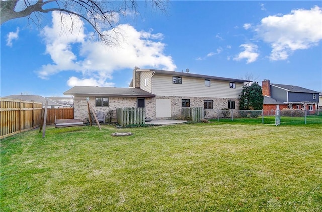 back of property with a lawn and a patio area