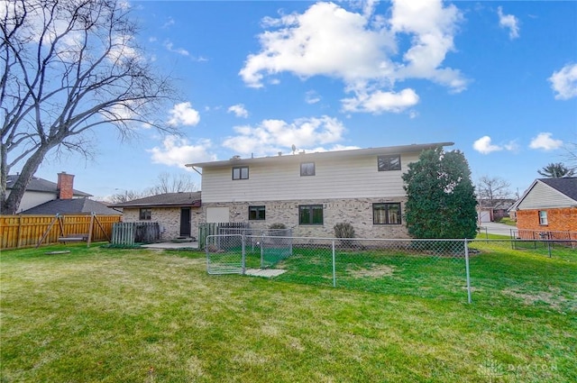 rear view of house featuring a lawn