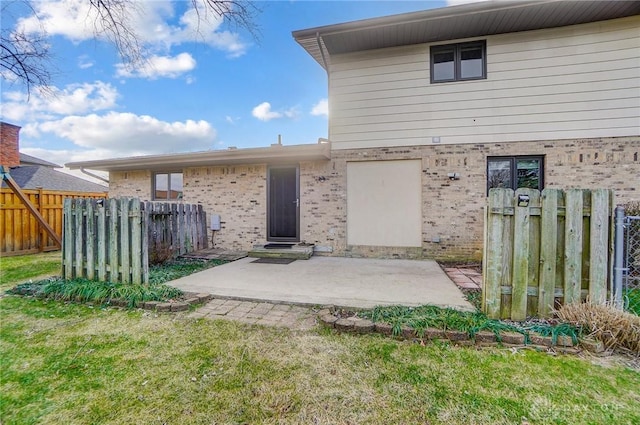 rear view of house featuring a yard and a patio area