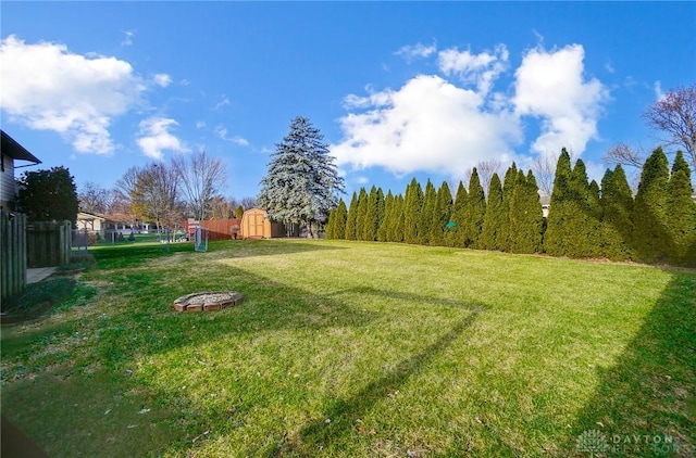 view of yard with a fire pit