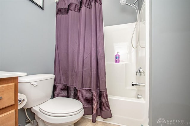 full bathroom featuring tile patterned floors, vanity, shower / tub combo, and toilet