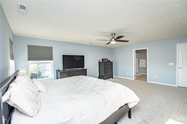 carpeted bedroom featuring a textured ceiling, ceiling fan, and connected bathroom