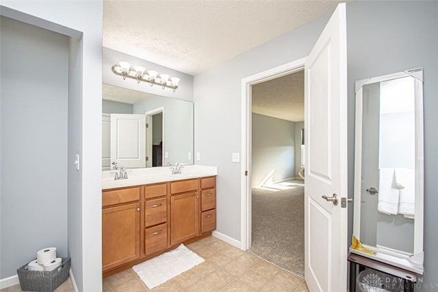 bathroom with vanity and a textured ceiling