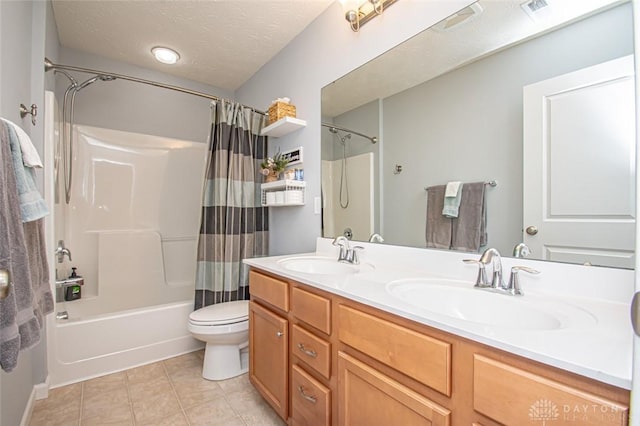 full bathroom featuring tile patterned floors, a textured ceiling, toilet, shower / tub combo with curtain, and vanity