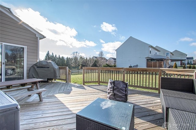 wooden deck with area for grilling and a lawn