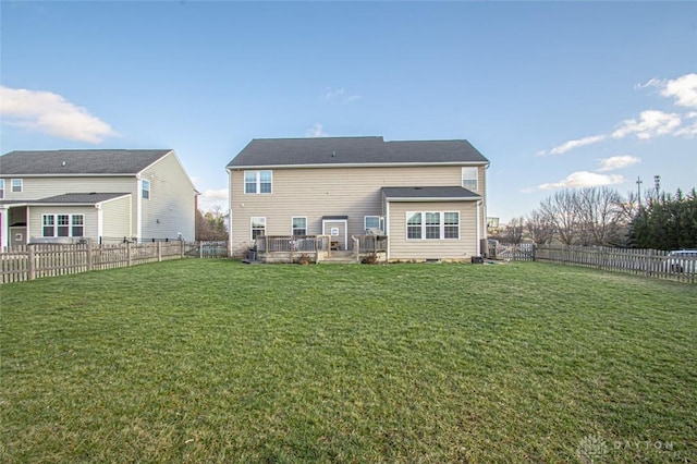 rear view of house featuring a yard